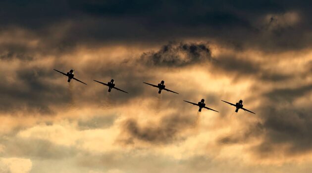 RAF Red Arrows display team approaching Sidmouth from the clouds, Devon, UK. Photo by Red Zeppelin