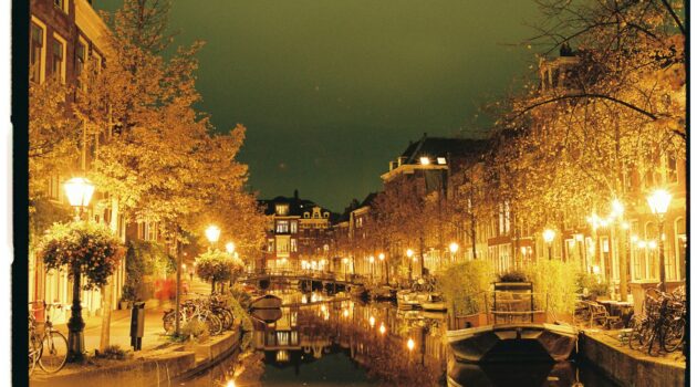 A scenic night view of the historic canal district in Amsterdam, Netherlands. Photo by Lawrence Krowdeed