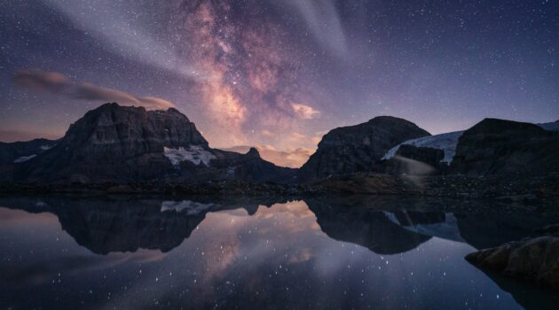Milky Way above an alpine lake in the mountains in Switzerland. Photo by Pascal Debrunner
