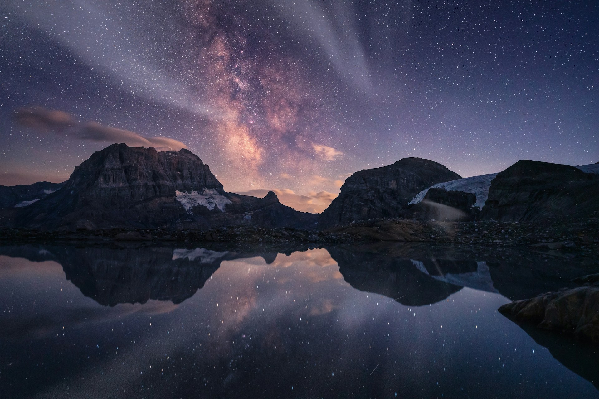 Milky Way above an alpine lake in the mountains in Switzerland. Photo by Pascal Debrunner