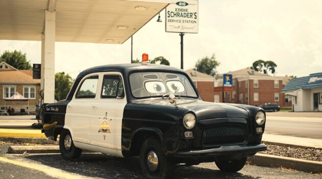 A vintage sheriff patrol car parked at a classic Route 66 gas station in Carthage, Missouri. Photo by Damian Kamp