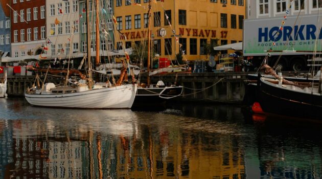 Sailboats in Nyhavn, a famous 17th-century waterfront and entertainment district in the Indre By (Inner City) of Copenhagen, Denmark. Photo by Frank Huang